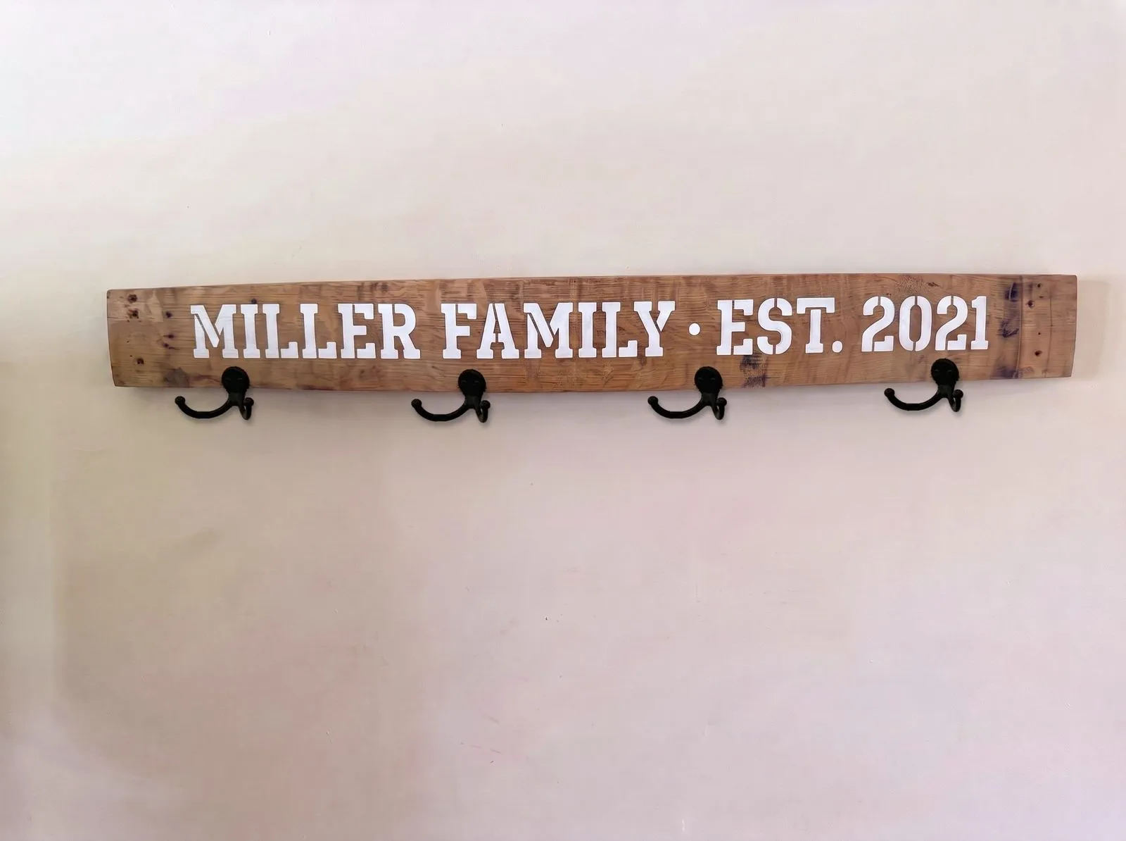Hand-painted lettering on a bourbon barrel stave