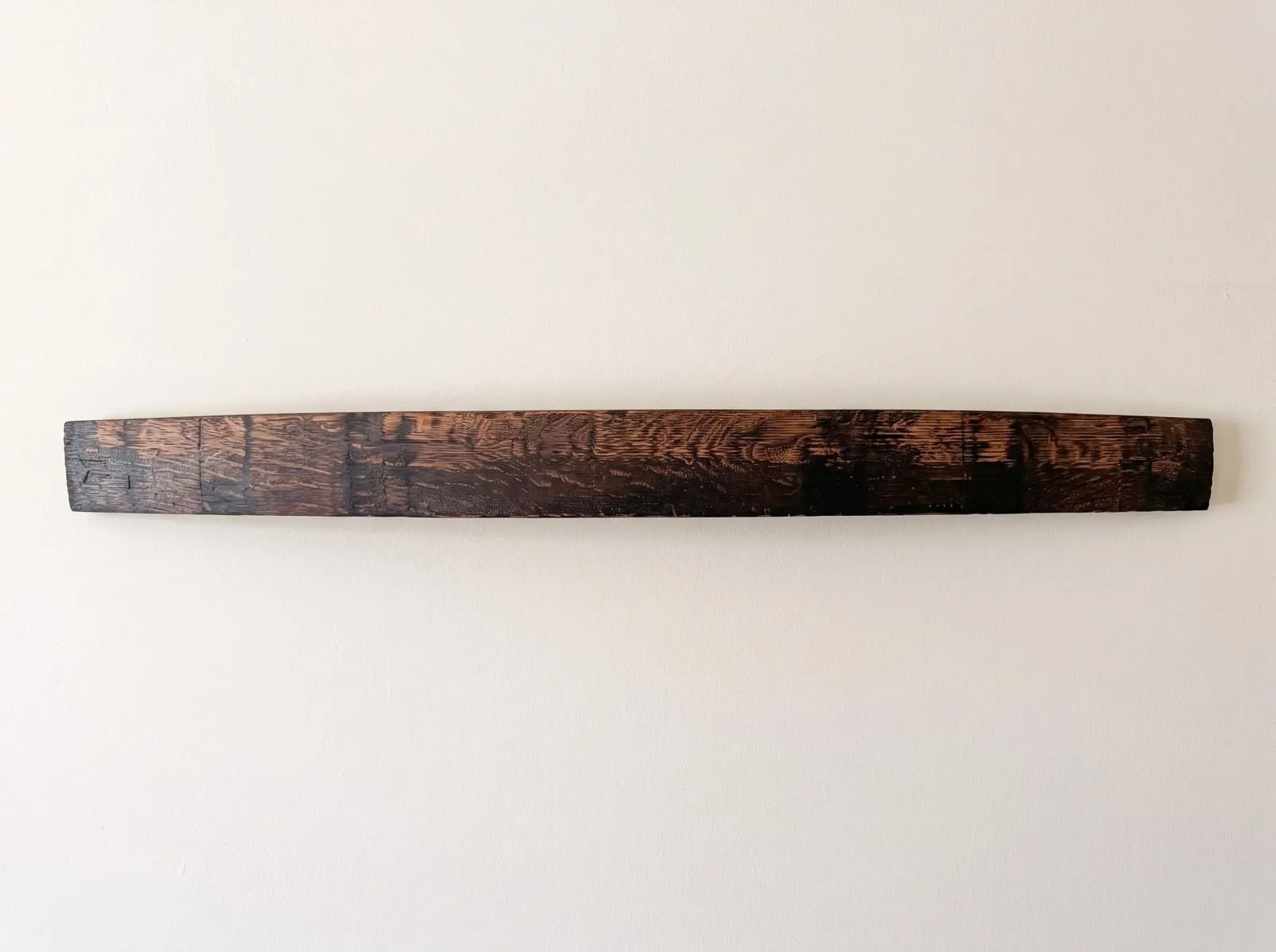 Raw charred bourbon barrel stave before lettering